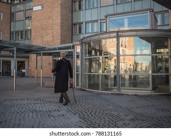 Oslo, Norway April 2017: Man With Stick Walk Outside The University Hospital Rikshospitalet
