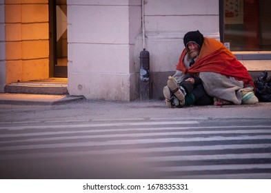 Oslo / Norway - April 2nd 2018:  A Man Sitting On The Street Begging For Money, Hisbelongings Are In Bags Around Him,