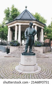 Oslo, Norway - August 2, 2019: Statue of Johan Halvorsen next to the National Theater near an arbor on Karl Johans gate street