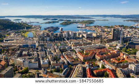 Oslo, Norway. Beautiful panoramic aerial view photo from flying drone for Oslo city center. Against the background of the sea, mountains and blue sky on a sunny summer day. (Series)
