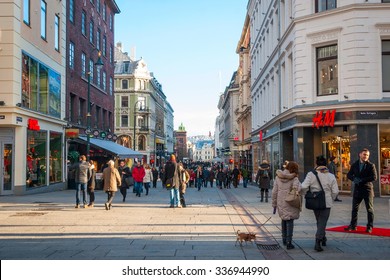 OSLO, NORWAY - JANUARY 29: People walking along the street in Oslo downtown in sunny winter day. Taken in Oslo, January 29, 2015.