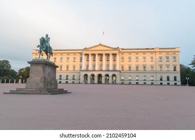 Oslo, Norway - September 24, 2021: View of the front facade of Slottet, Royal Palace with equestrian monument King Karl Johan.