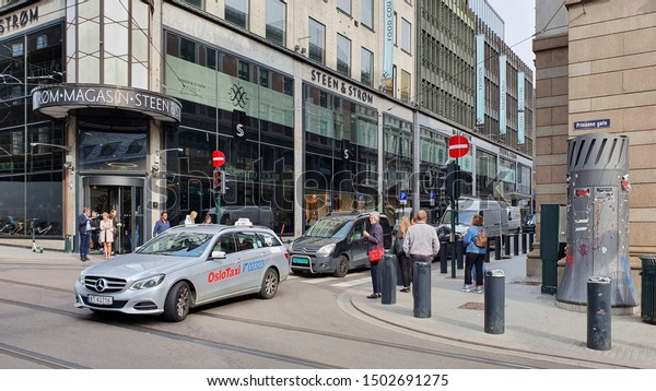 OSLO,\
NORWAY - SEPTEMBER 6, 2019: Cars and people in street crossing on\
Prinsens gate in the city centre of Oslo,\
Norway