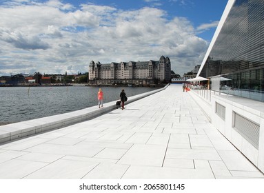 Oslo, Norway-June 16, 2009: Woman With Dog And A Girl Walking By The Sea Side Of The Opera House In Oslo.