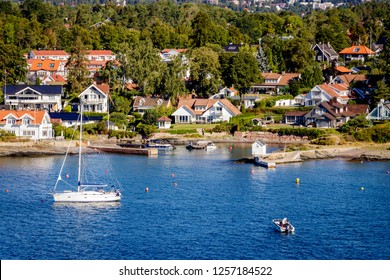 The Oslofjord Is An Inlet In The South-east Of Norway Connecting The Baltic Sea With The City Of Oslo. Looking At A Small Suburb Of The City With A Sailing Boat In The Foreground.