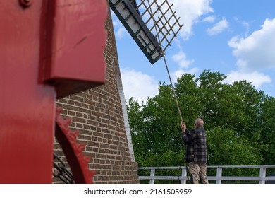 Oss, North Brabant, the Netherlands - May 28 2022: the miller of flour miller Zeldenrust (1860) is pulling the catch rope. This releases the brake so the blades can move.