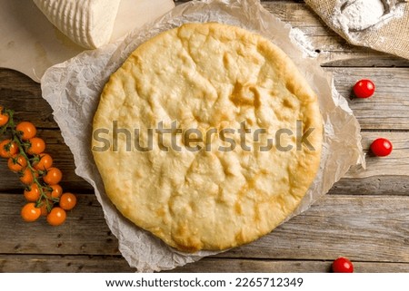 Ossetian pie with cheese on old wooden table top view Stock photo © 