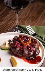 Osso Buco In Bianco Is Traditional Italain Dish From The Milan Area. The Veal Meat Slices With Marrow Bone Are Being Cooked In A Large Casserole Along With Root Vegetables, Spice And Wine Sauce