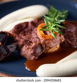 Osso buco, cooked Veal shank. Ossobuco meat. on a wooden board, serving in a restaurant, menu food concept