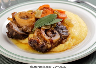 Ossobuco with polenta, vegetables, and sage leaves