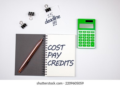  Ost Of Paying Loans On A Notepad Next To The Calculator. The Concept Of Calculating The Payment Of The Loan Amount