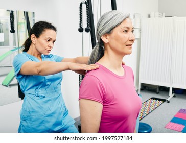 Osteopath Examines A Spine Of A Mature Woman. Medical Exam Of Scoliosis, Osteochondrosis At Rehab Clinic