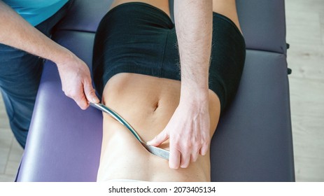 Osteopath Performing Diaphragm Coastal Release With IASTM Tool, Instrument Assisted Soft Tissue Mobilization Technique For Soft Tissue Treatment