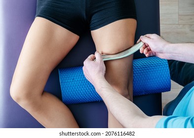 Osteopath performing IASTM myofascial release for quadriceps, quads pain releif