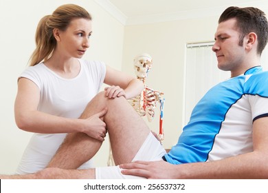 Osteopath Treating Male Patient With Sports Injury