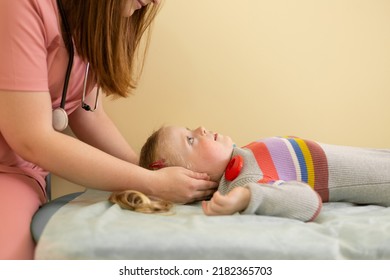 Osteopath Woman Doing Head Massage To 4 Year Old Girl