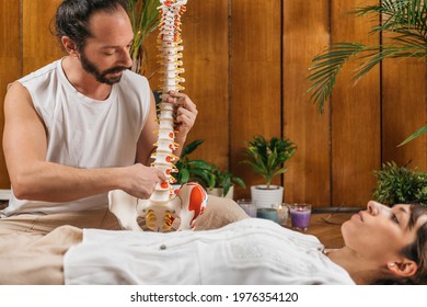 Osteopathy Training Class. Osteopathy Male Trainer Educating Patient with Flexible Spine Model - Powered by Shutterstock