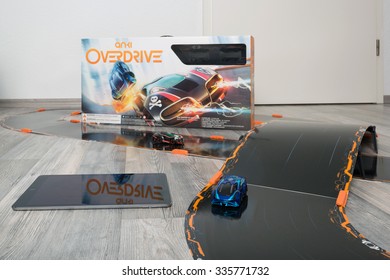 OSTFILDERN, GERMANY - NOVEMBER 1, 2015: Test Drive Of The New Anki Overdrive Smart Toy Car Racing Using An App On The Apple IPad To Steer The Small Cars. US Producer Anki Created An Innovative Toy