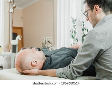 Ostheopatic treatment of a patient using CST gentle hands-on technique, central nervous system tension relieve