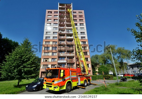Ostrava, Czech republic - june 15\
2022: Firefighters at a high-rise apartment building are testing\
the features and reach of a new car ladder fire\
truck\
