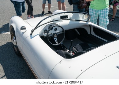 Ostrava, Czechia - 06.05.2022: High Angle From Behind Shot Of Interior Of White Skoda Banham 130 Spyder. Convertible Veteran Car. People Admiring Retro Cars During Veteran Rally Event In The City. 