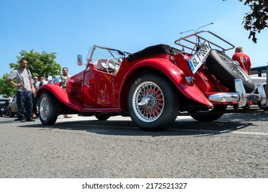 Ostrava, Czechia - 06.05.2022: High Angle From Behind Shot Of Red Panther Lima MK1 Convertible Veteran Car. People Admiring Retro Cars During Veteran Rallye Event In The City. 