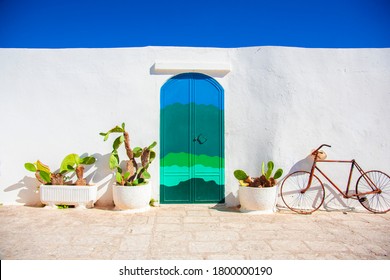 Ostuni, Italia - 20 August 2020. Blue door with cactus and the traditional white walls in the town of Ostuni (Puglia - Italy).

