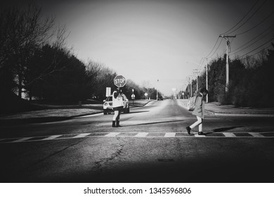 Oswego, Illinois- February 17, 2019: A Crossing Guard Yields The Right Of Way To A Student Attending The Nearby School.