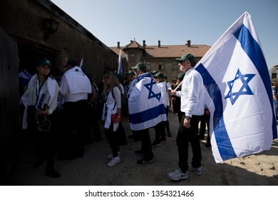 Oswiecim, Poland - 12 April 2018: International Holocaust Remembrance Day. Thousands Of Judes With Israeli Flag Come To Auschwitz To Join And Pray The March Of The Living In German Concetration Camp