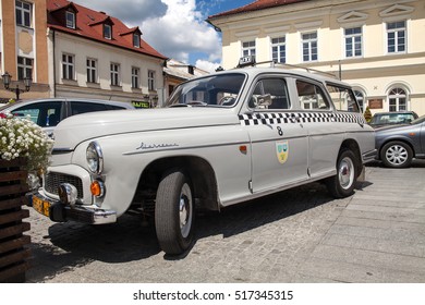 OSWIECIM, POLAND - JULY 9, 2016 ;  Exhibition Of Old Cars. Old Design In Cars. Beautiful White Old Antique Warszawa Taxi  Car,, Side View. Oswiecim City Center.