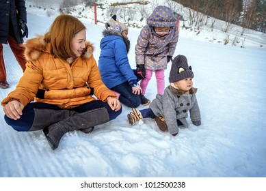 Otaru, Hokkaido-January 09, 2018; Baby Playing On Snow Sledding With Trey Or Snow Rafting At Winter Festival In Otaru, Hokkaido, Japan