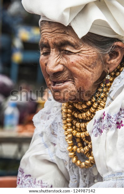 OTAVALO, AUGUST 4, 2012: Indian women in national\
clothes sells the products of her weaving, as usual on weekdays on\
the most famous markets in South America, on August 4, 2012 in\
Otavalo, Ecuador