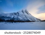 Otertind mountain, Lyngen Alps, Norway. Natural andscape. Starry sky and moon light. Long exposure photography in the mountain region. Winter night landscape with starry sky. 