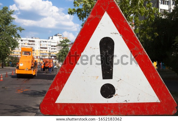 Other Dangers sign. Dangerous area. Traffic\
sign. Road works in the\
background.