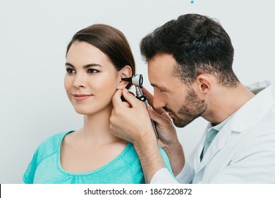 Otolaryngologist Checking Adult Female Ear Using Otoscope. Hearing Exam For Hispanic Woman. Otitis Media, Ear Inflammation