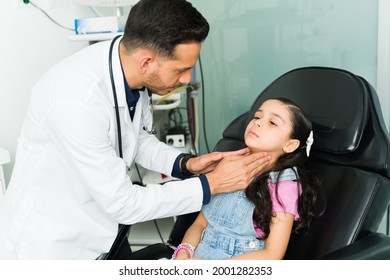 Otolaryngologist doctor examining a little girl. Sick elementary kid lying on the examination chair and getting diagnosed with strep throat - Powered by Shutterstock