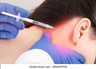 An Otolaryngologist Performs A BTE Blockade On A Patient With Pain Medication For Ear Disease. Tinnitus And Vertigo Treatment Concept