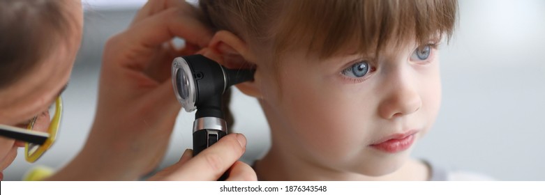 Otorhinolaryngologist examines little girl's ear with otoscope. Adenoiditis as cause of otitis media in children concept. - Powered by Shutterstock