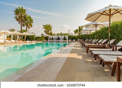 Otranto, Puglia / Italy - september 2019: beautiful swimming pool of a luxury wellness resort with umbrellas