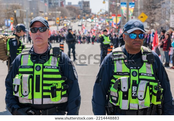 Ottawa, Canada – April 30\
2022: Ottawa Police and other first responders control a crowd\
gathered at the Canadian War Memorial during Rolling Thunder convoy\
protests