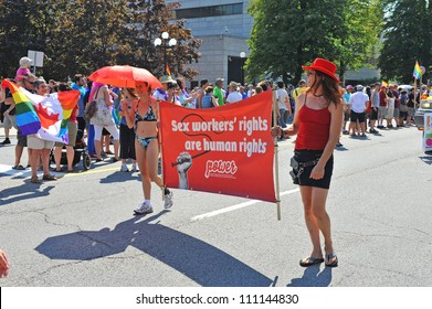 OTTAWA, CANADA - AUG 26:  Unidentified sex workers carry a sign for their rights in the Pride Parade on August 26, 2012 in Ottawa, Ontario, Canada.