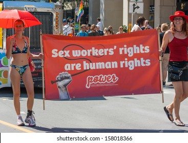 OTTAWA, CANADA - AUGUST 26: Women carrying a banner about sex workers' rights in the Capital Pride Parade on August 26, 2012 in Ottawa, Ontario.