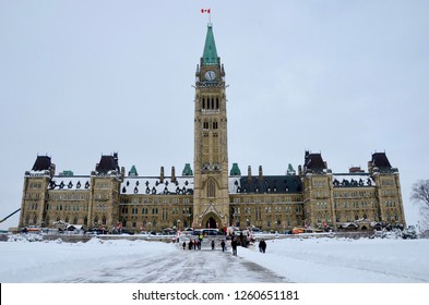 Ottawa, Canada - February 15, 2017: Centre Block Of Canadian Parliament Building With Peace Tower On Cold Winter Day With People Walking In Foreground