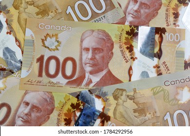 Ottawa, Canada - Jul 25, 2020: A Scramble Of $100 Canadian Dollar Banknotes Illustrative Image Concept For Canadian Economic Business Development. These Frontier Series Was First Circulated In 2011.