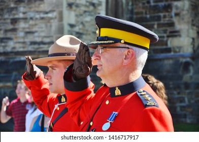 OTTAWA, CANADA - JULY 1, 2011: RCMP Police With Antique Red Uniform Solute On Canada Day In The Parliament Plaza In Ottawa, Ontario, Canada. 