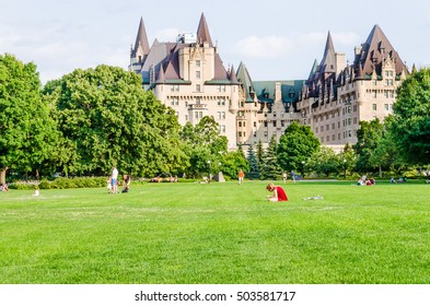 Ottawa, Canada - July 24, 2014: People In Majors Hill Park By Fairmont ChÃ¢teau Laurier Hotel