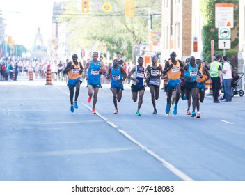 OTTAWA, CANADA - MAY 24, 2014: The Winner, Wilson Kiprop, And Other Unidentified Elite Athletes Running In The 10K Race In The Tamarack Ottawa Race Weekend. Kenyans Won The Top Five Places.