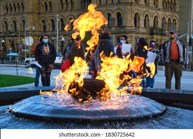 Ottawa, Canada.  October 1st, 2020. Behind Centennial Flame Burning, People At Vigil For First Nations Woman Joyce Echaquan Who Died In Hospital Earlier This Week