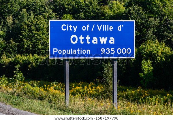 Ottawa city entrance Information Road blue Sign on\
the roadside, Canadian two languages French and English signs,\
Ville d\'ottawa, Canada