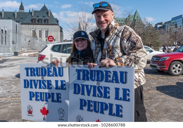 OTTAWA - FEB 18,2018: Canadians demonstrate on\
Parliament Hill to ask  Prime Minister to stop dividing people and\
to apologize for taking side with hijab hoaxers. Chinese signs:\
Asians silent no more!